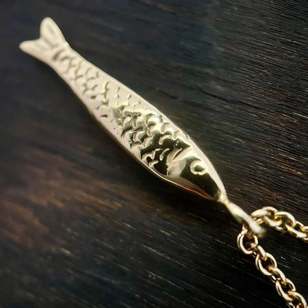 close up detail photo of the gold fish Necklace,  gold Sardine Necklace showing it's fish scales.