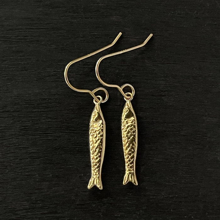 detail photo of gold sardine fish hook earrings made by jewel thief Brighton.