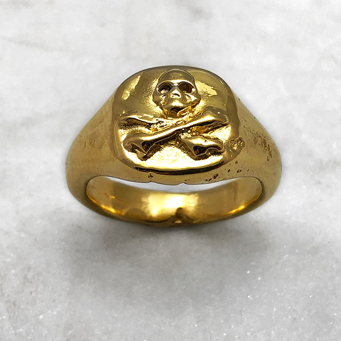 gold skull and crossbones ring detail view